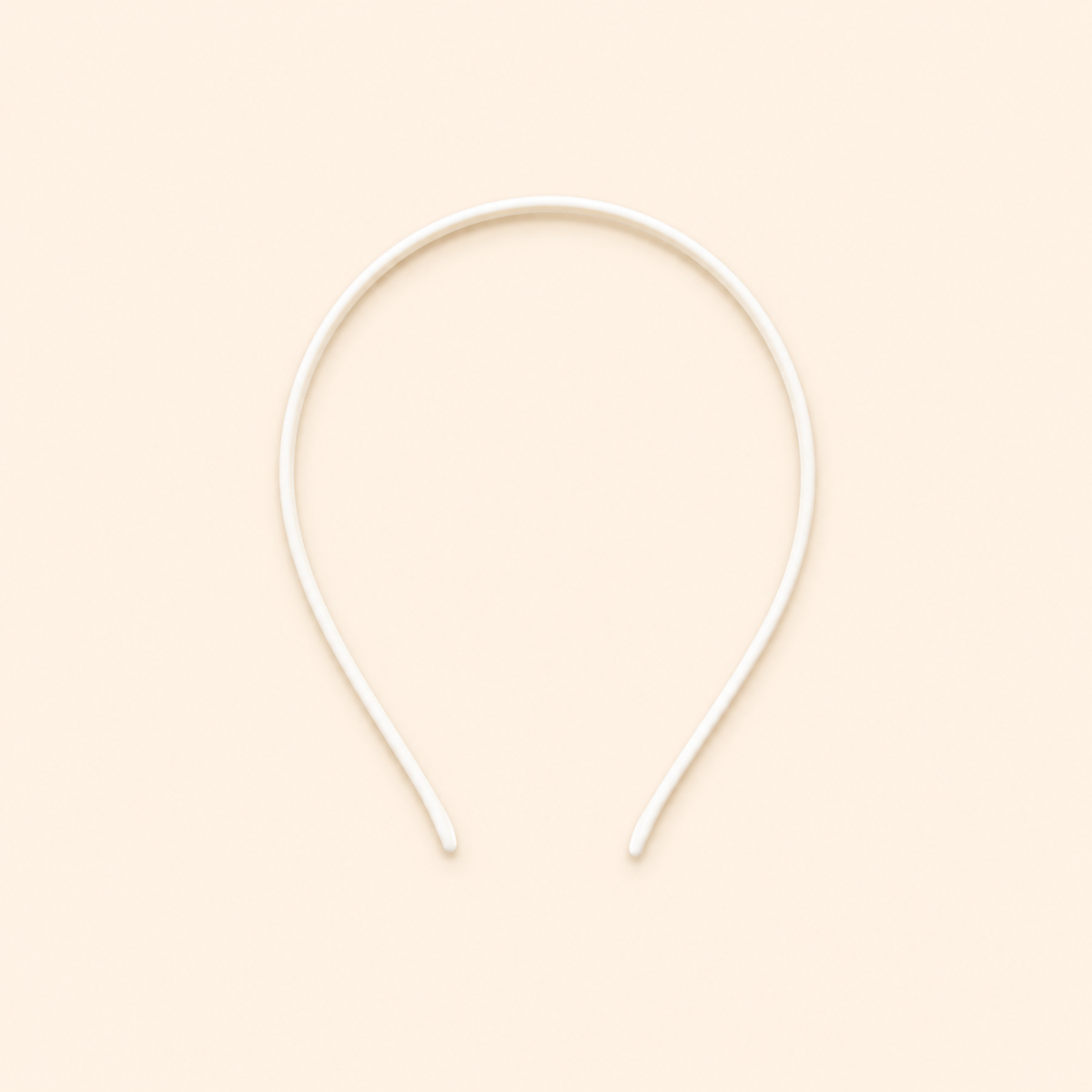 White headband on a beige background